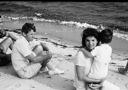 bobby-kennedy-looks-at-jackie-kennedy-holding-her-son-in-the-summer-of-1964