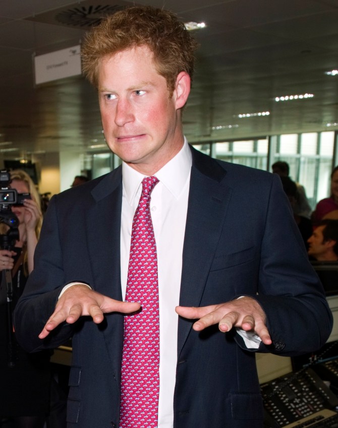 Britain's Prince Harry reacts on the trading floor of  BGC Partners, in London