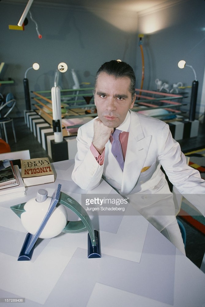 German fashion designer Karl Lagerfeld poses with a teapot from his Memphis collection, and the new novel 'Lincoln' by Gore Vidal, 1984. CREDIT: JURGEN SCHADEBERG