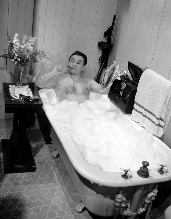 Actor Edward G. Robinson portrayer of tough guy parts in the movies, does his best to keep a stern face as he underwent a bubble bath in a movie scene in Hollywood on March 17, 1948. He has his inevitable cigar. (AP Photo)