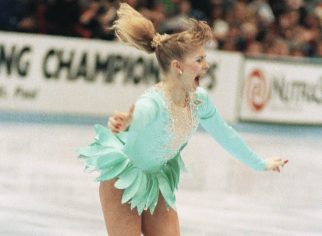 A jubilant Tonya Harding acknowledged the crowd as she came out of her successful triple axel on her way to winning the U.S. Figure Skating Championships on Feb. 16, 1991 in Minneapolis. Harding, of Portland, Oregon, became the first American woman to perform a triple axel in competition. (AP Photo/Jim Mone)
